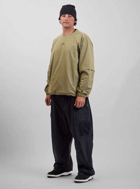 Man wearing black wide-leg cargo pants with olive green pullover and black beanie