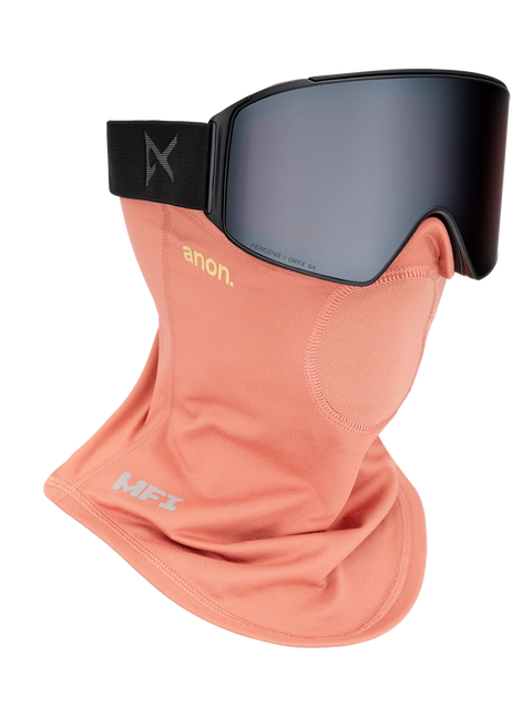 Anon MFI midweight neckwarmer in salmon pink paired with black Anon ski goggles