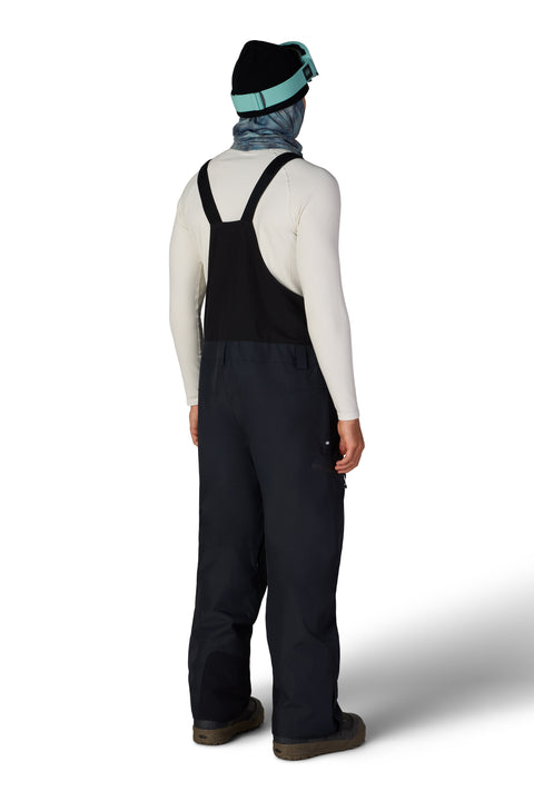 686 Men's Lockup Shell Bib Pant in dark navy, rear view with black suspenders