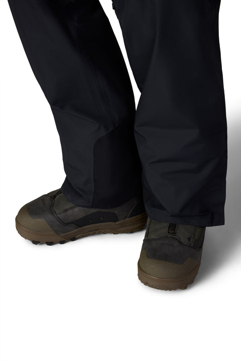 686 men's black shell bib pant hem detail with olive snowboard boots