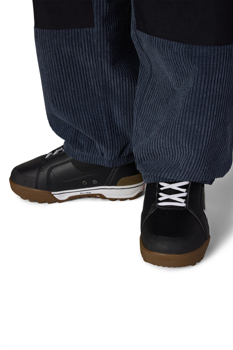 686 Men's Ghost 2.5L navy corduroy snow pants with black gum-sole snowboard boots