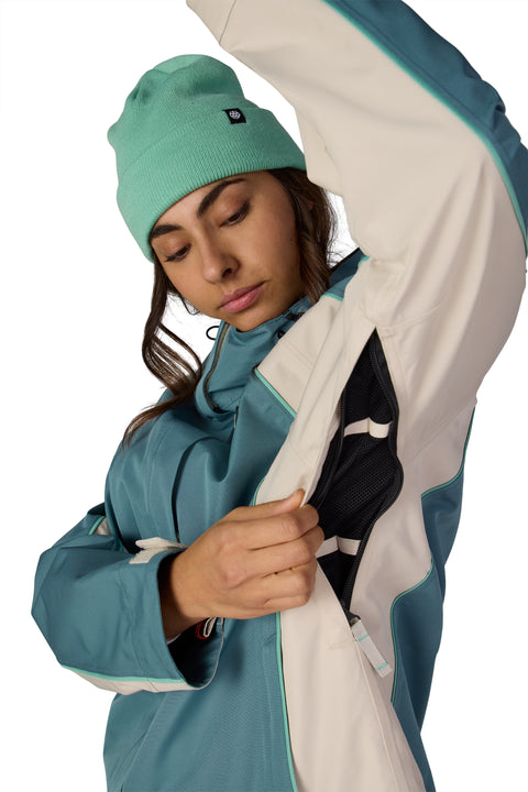 686 Women's Hologram Shell Jacket in teal and cream showing underarm ventilation zipper