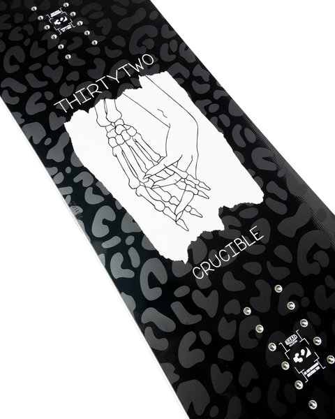 ThirtyTwo Crucible snowboard featuring black leopard print base and skeleton hand graphic