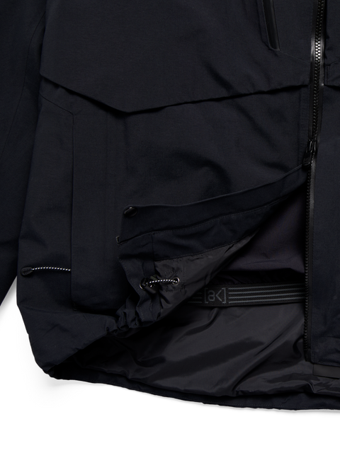 Black Burton ak Swash jacket interior showing powder skirt and waist strap detail