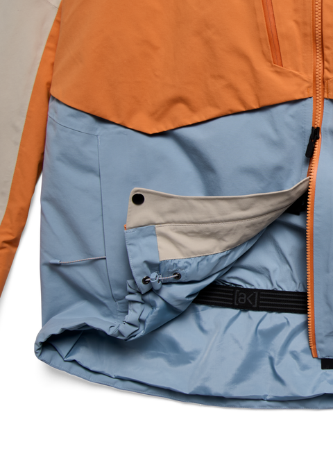 Burton ak Swash jacket in orange and blue with powder skirt and side zipper detail