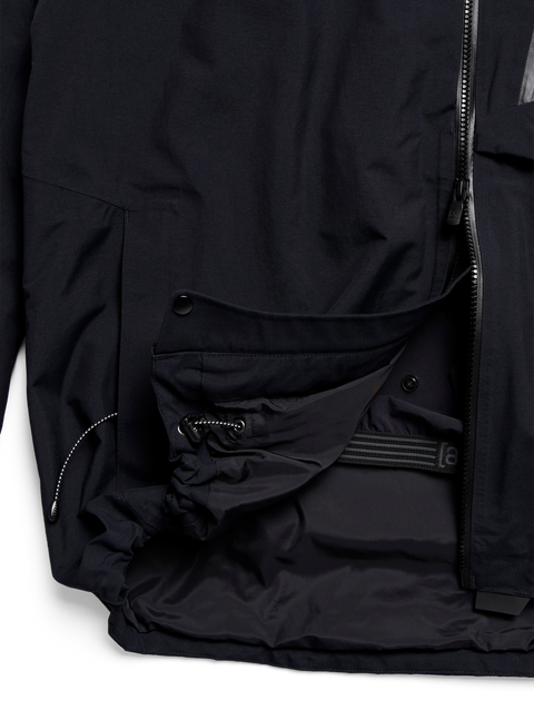 Black GORE-TEX jacket interior showing multiple pockets, drawcord hem, and zipper detail