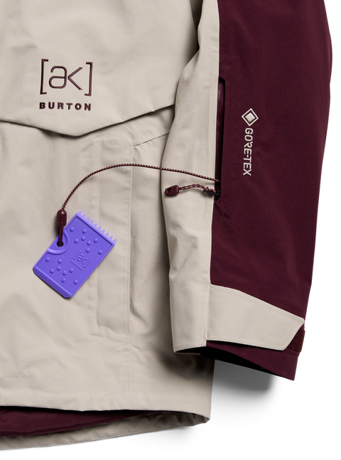 Burton [ak] Cyclic GORE-TEX 2L jacket in tan and burgundy with purple wax scraper hang tag