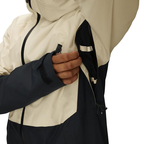 Close-up detail of jacket chest pocket zipper on two-tone men's ski jacket