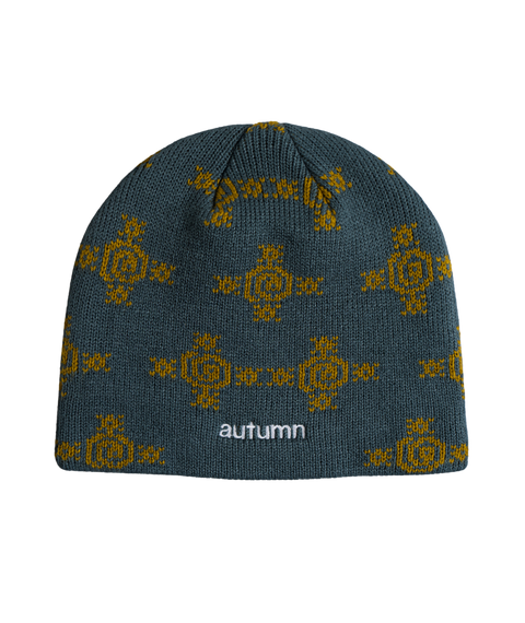 Autumn Glyphs Beanie in teal with gold geometric knit pattern and embroidered logo