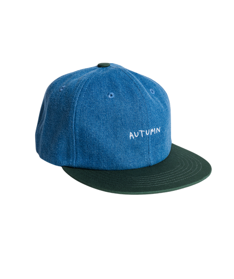Autumn six panel snapback cap in blue denim with dark green brim