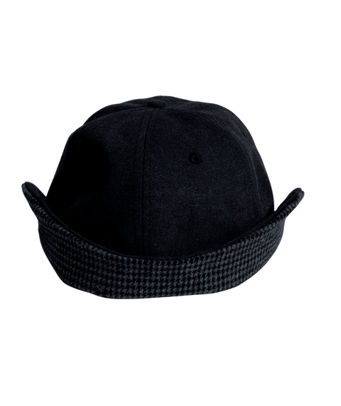 Black canvas flap cap with houndstooth patterned brim and side ear flaps