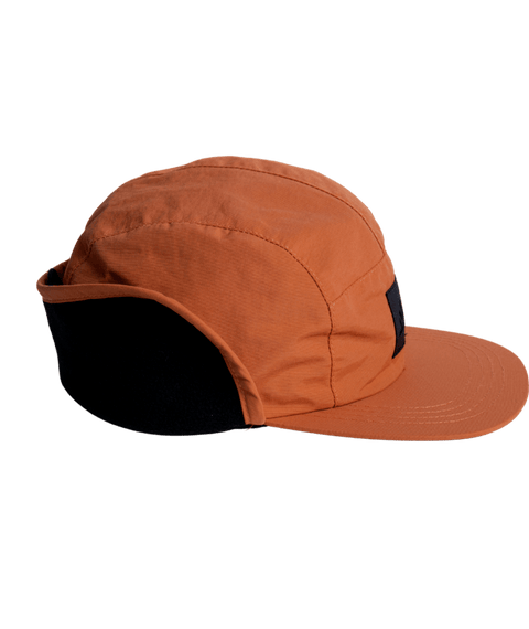 Autumn DWR Flap Cap with structured panels, flat brim, and ear flap protection