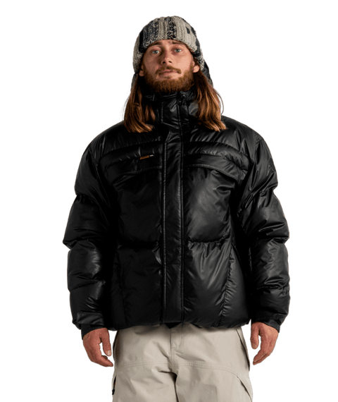 Autumn Magma Puffy Jacket in black, worn by male model with knit hat