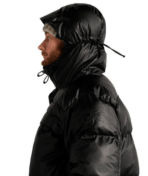 Men's black glossy puffer jacket with adjustable hood and quilted panels