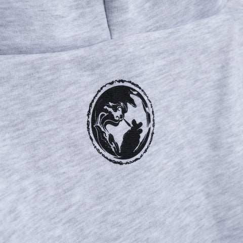 Gray hoodie chest detail with circular black logo of woman lighting cigarette