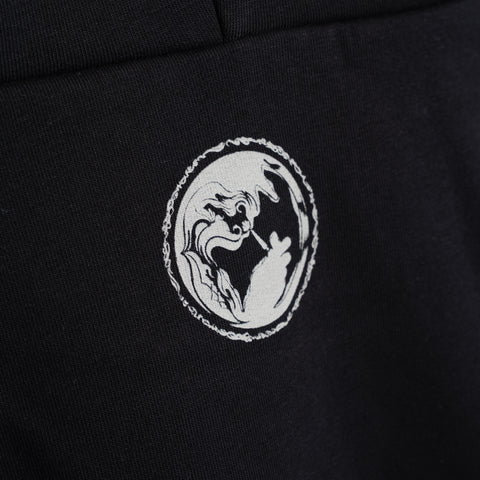 Close-up of black hoodie with circular dragon graphic logo on chest