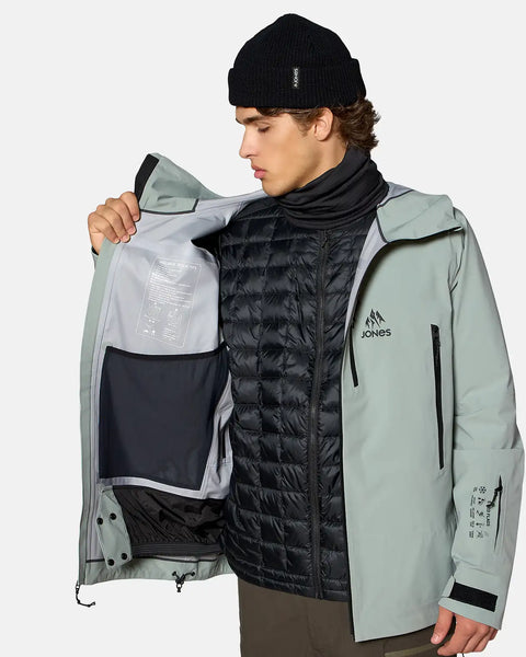 Jones men's sage green 3-layer stretch snow jacket shown open revealing interior pockets and avalanche tips