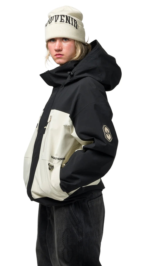 Black and cream insulated hooded jacket with large front pocket and logo patch