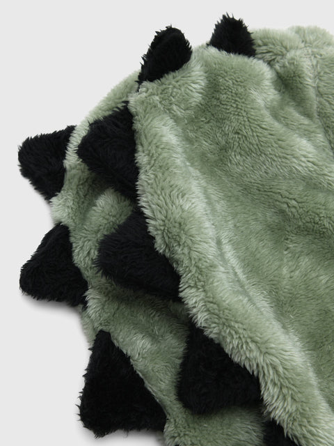 Close-up detail of a sage green and black fluffy faux fur kids hooded blanket with spikes