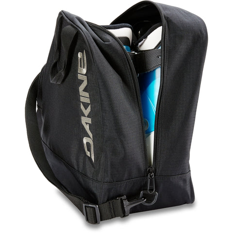 Dakine boot bag open showing ski boots inside with shoulder strap and zipper closure