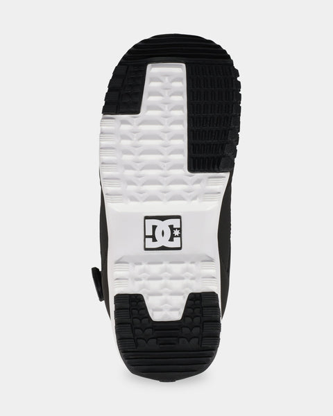 Bottom sole view of DC snowboard boot showing herringbone tread pattern and DC logo