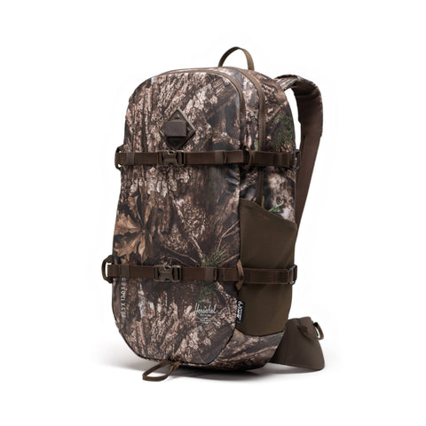 Herschel All Season 29 backpack in woodland camouflage pattern with compression straps, three-quarter view