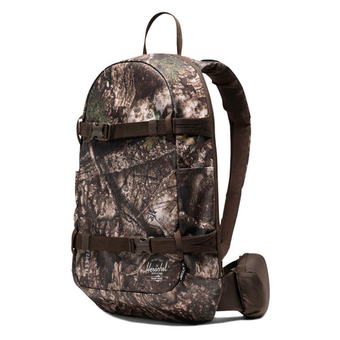 Herschel backpack in woodland camouflage print with brown straps and buckle closures