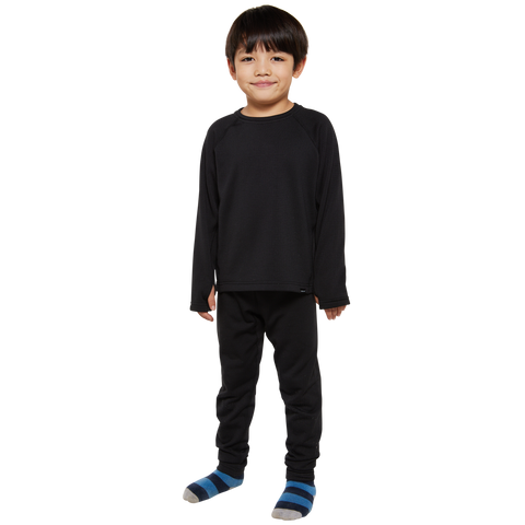 Child model wearing matching black long-sleeve thermal top and pants layering fleece set