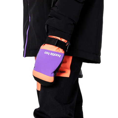 Child wearing Hootie Hoo Bearclaw mittens clipped to jacket sleeve, shown from side angle