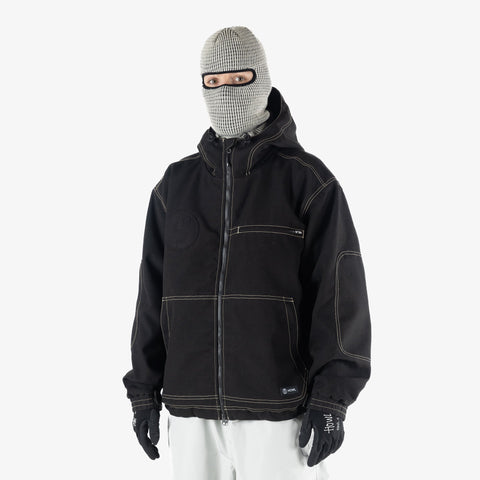 Model wearing Howl workwear jacket with balaclava, white pants, and black gloves