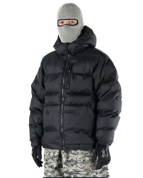 Model wearing Howl Men's puffy hooded down jacket with balaclava and patterned snow pants