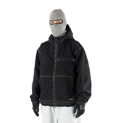 Man wearing black Howl workwear jacket with contrast stitching, hood up, and balaclava
