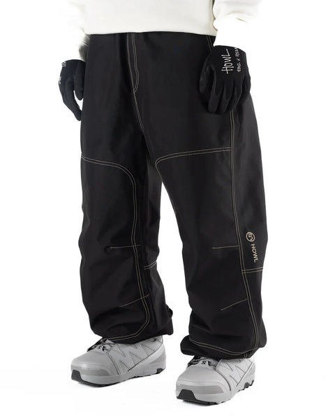 Howl men's black workwear snowboard pants with contrast stitching and snowboard boots