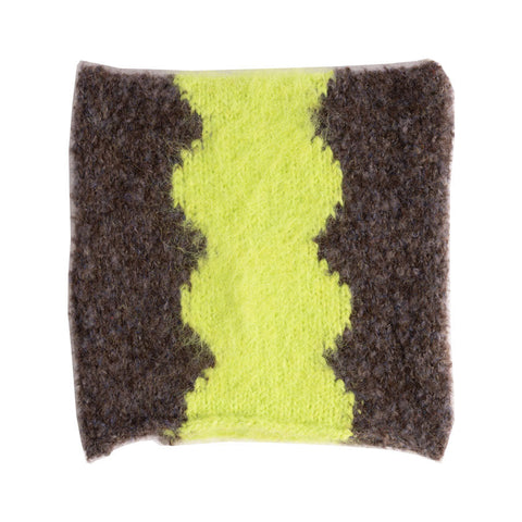 Knitted square beanie with neon yellow zigzag stripe on grey textured background, laid flat