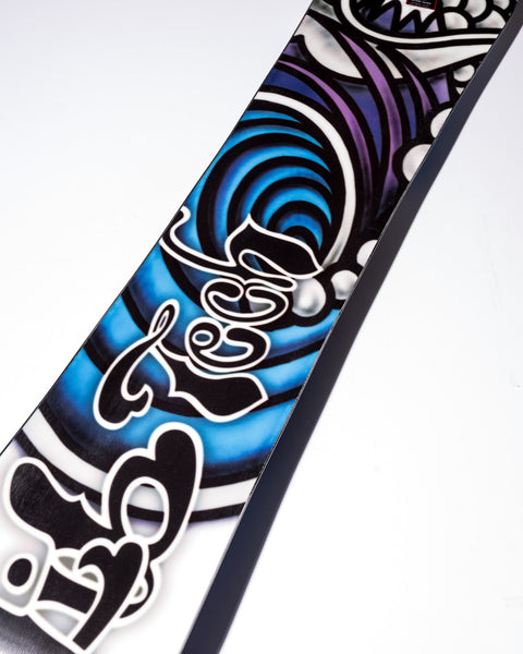 Close-up detail of Lib Tech snowboard featuring bold blue, purple, and black graphic design