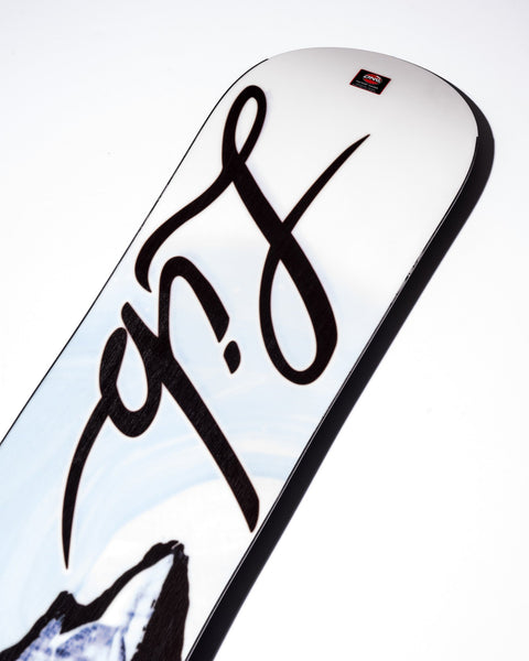 Close-up detail of Lib Tech Cortado snowboard top sheet showing bold script graphic and mountain artwork