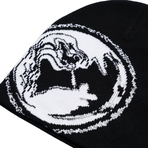 Close-up detail of black knit beanie featuring woven dragon graphic in black and white