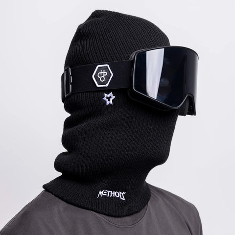 Black knit balaclava with Method Mag branding worn with matching ski goggles on model