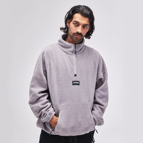Male model wearing Method Mag quarter-zip fleece pullover with kangaroo pocket and logo patch