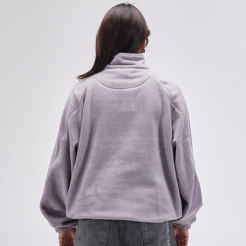 Back view of oversized quarter-zip fleece pullover with high collar and elasticated cuffs