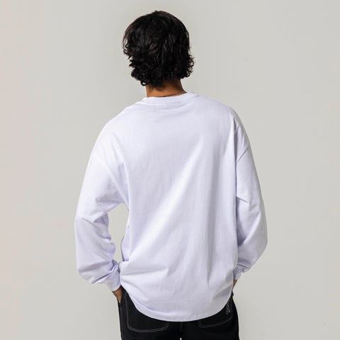 Back view of model wearing an oversized long-sleeve T-shirt with black jeans