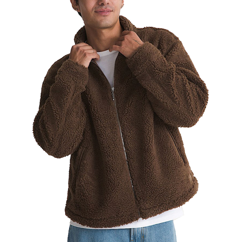Man wearing a brown sherpa zip-up jacket with stand collar and front pockets