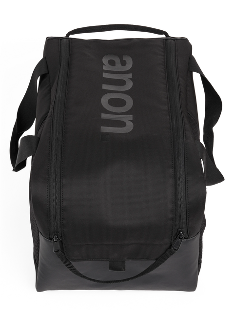 Anon black helmet bag with top handle, shoulder straps, and zippered compartments